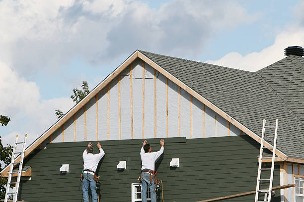 Professional Storm Damage Siding Repair technician working in Corolla, NC